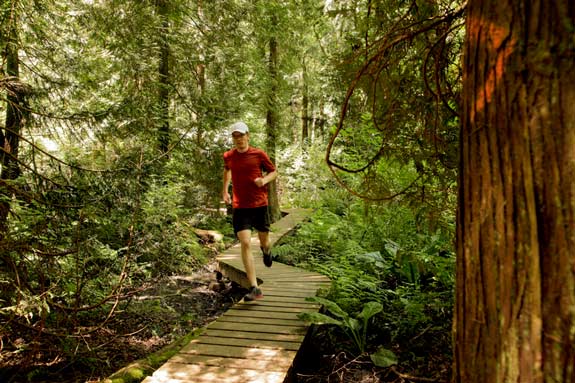 person running on outdoor trail