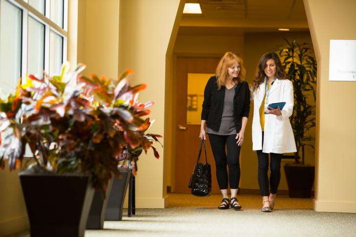 doctor walking patient down hallway