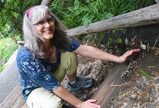 Cindy Wenner crouched by japan mushrooms