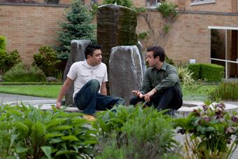 two people sitting in bastyr courtyard