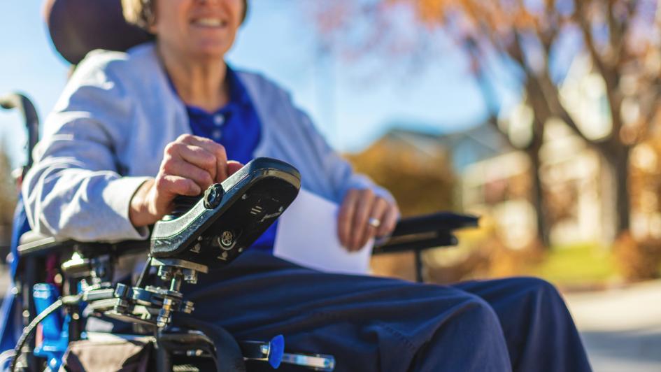 person in wheelchair smiling