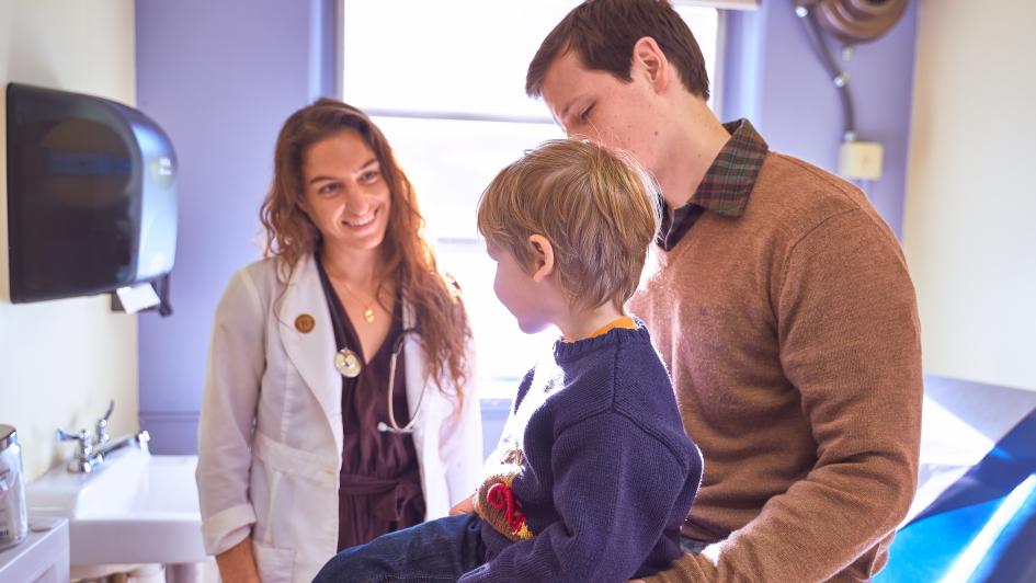 doctor with young child and parent